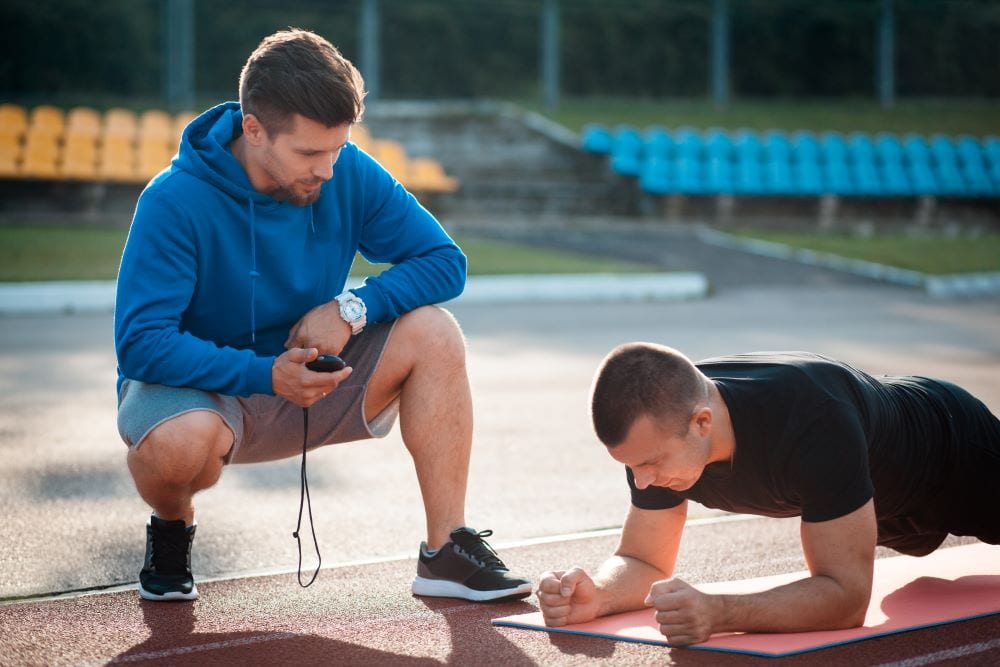 A coach pushing the trainee to do his best. What Does a Recovery Coach Do?