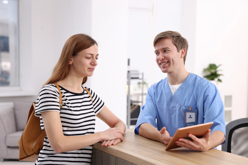 A healthcare professional helping a family understand insurance for rehab in another state.