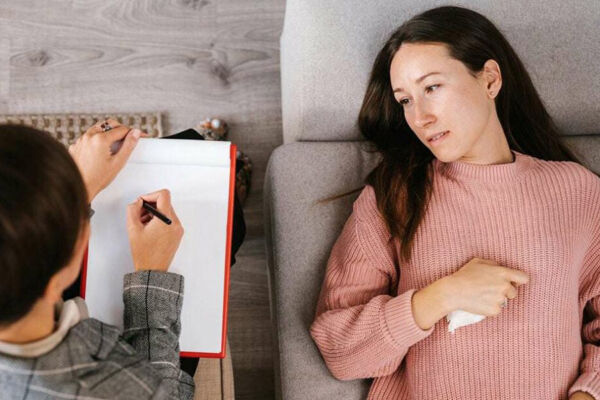 A therapist engaging in Cognitive Behavioral Therapy (CBT) with a patient during one of the therapeutic day treatment programs. A therapist engaging in Cognitive Behavioral Therapy (CBT) with a patient during one of the therapeutic day treatment programs.