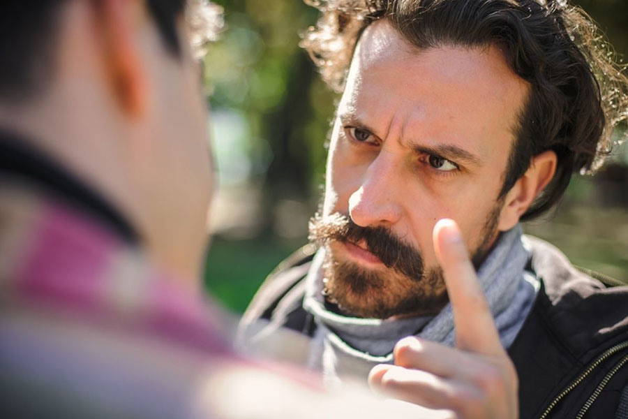 Adult man confronting another person and is displaying a violent and risky behavior Adult man confronting another person and is displaying a violent and risky behavior