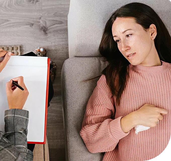 woman lying on couch getting therapy from man