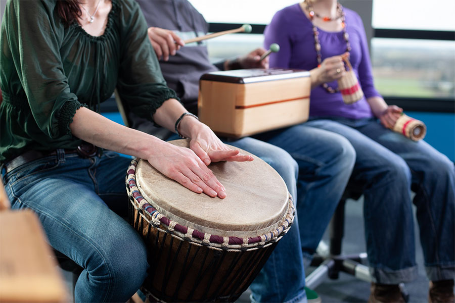 Group of people playing musical instruments during recreational therapy for addiction and mental health treatment. Group of people playing musical instruments during recreational therapy for addiction and mental health treatment.