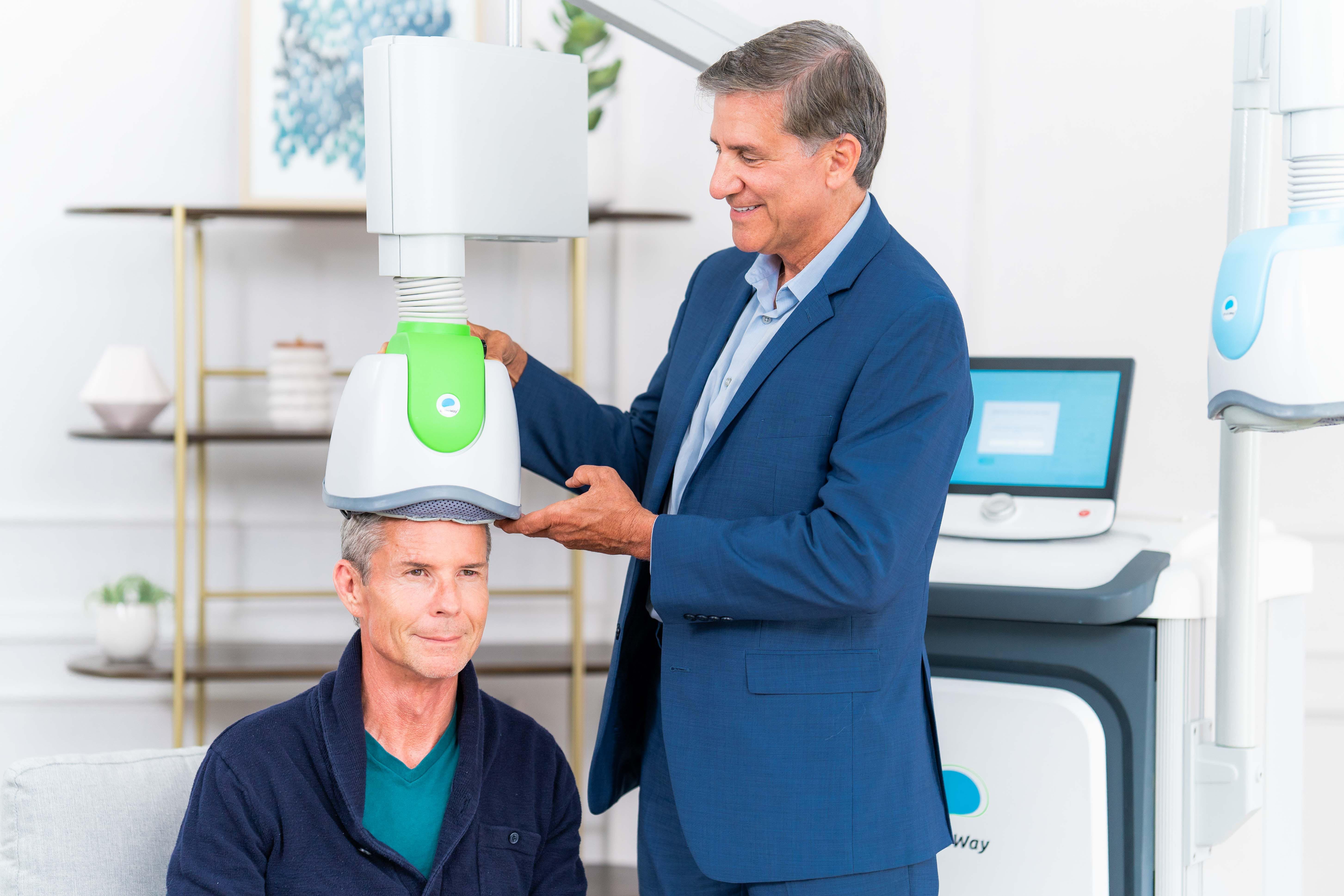 Clinician administering a non-invasive brain stimulation session to an older patient, demonstrating how TMS for dementia may support cognitive function