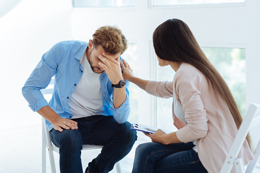 Therapist consoling patient, showcasing mental health continuum of care support