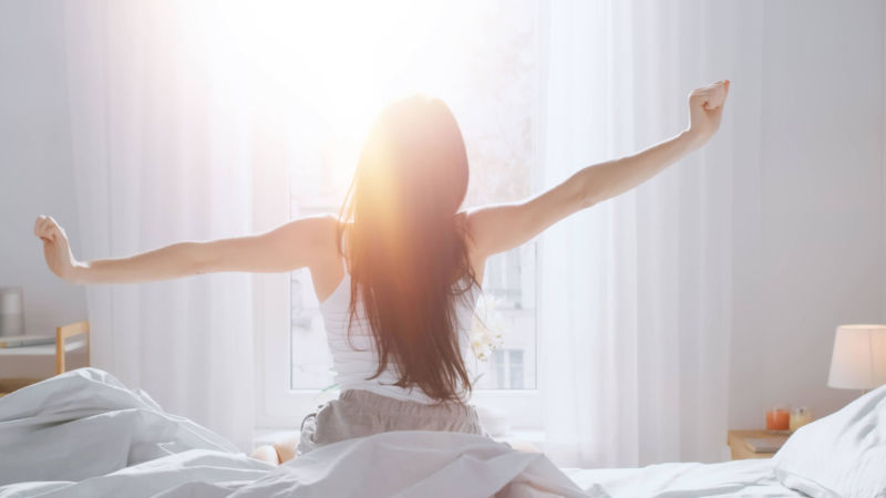 Young lady woke up from a good sleep. Overall health is the main importance of sleep in addiction recovery. Restful sleep can provide the energy needed to battle drug addiction.