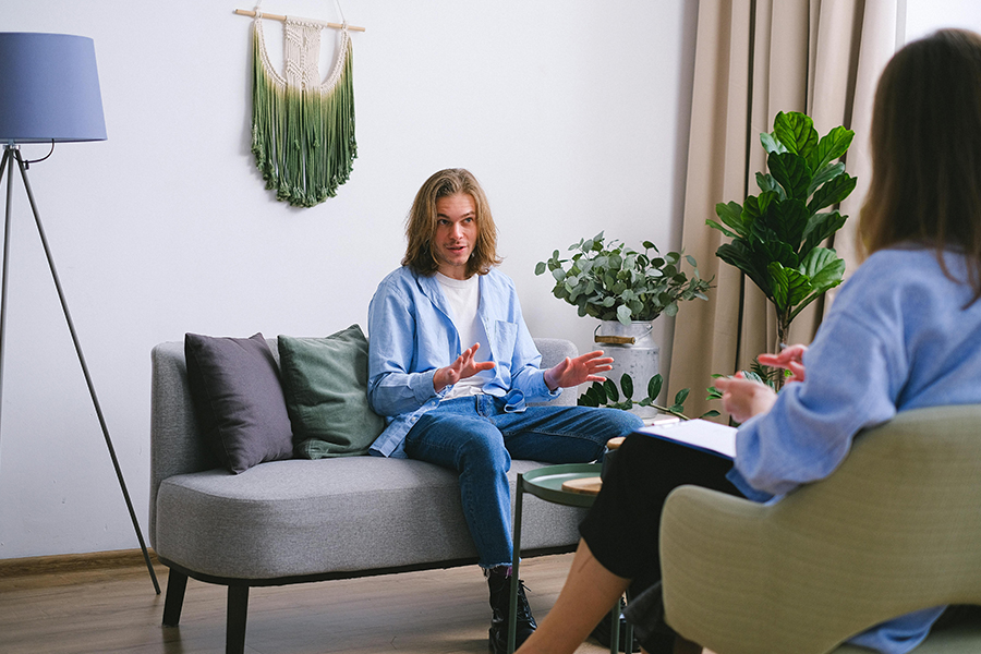 Young man participating in an individual therapy session as part of the decision-making process for inpatient vs outpatient rehab