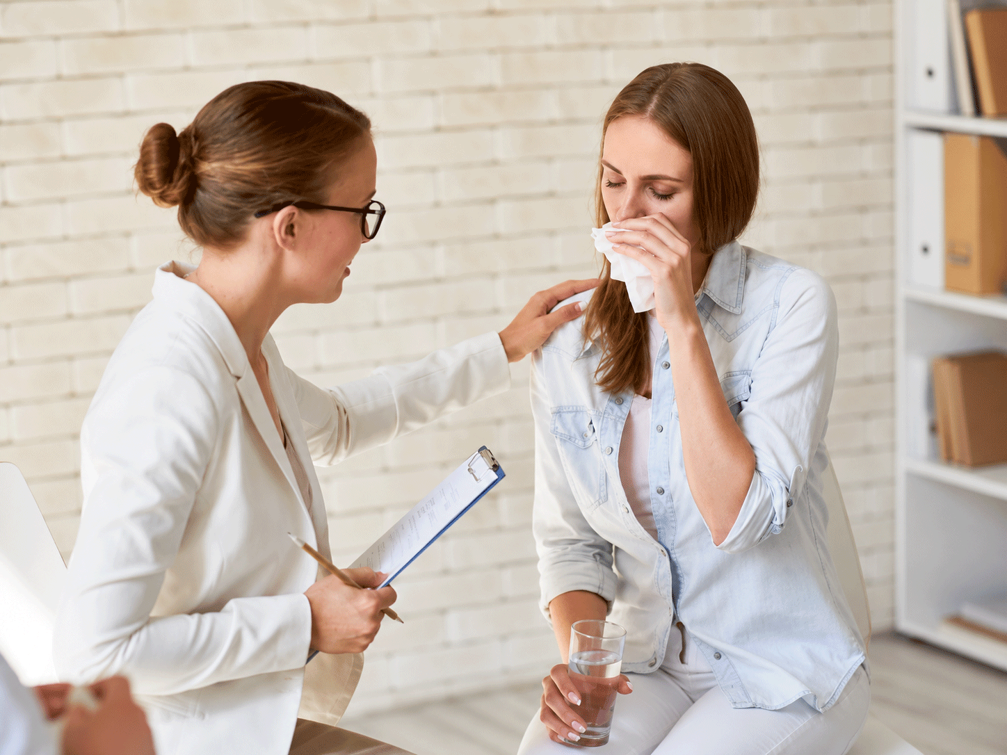 female therapist consoling women who is upset