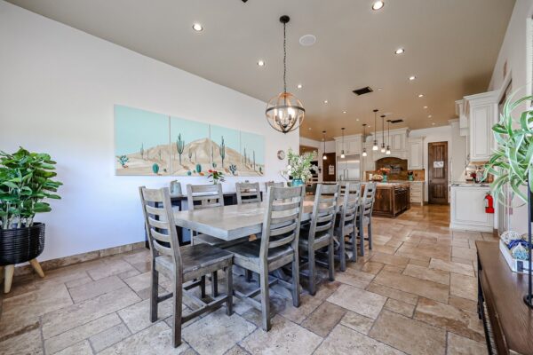 Dining room with a long wood table at the Camelback Recovery residence in Peoria