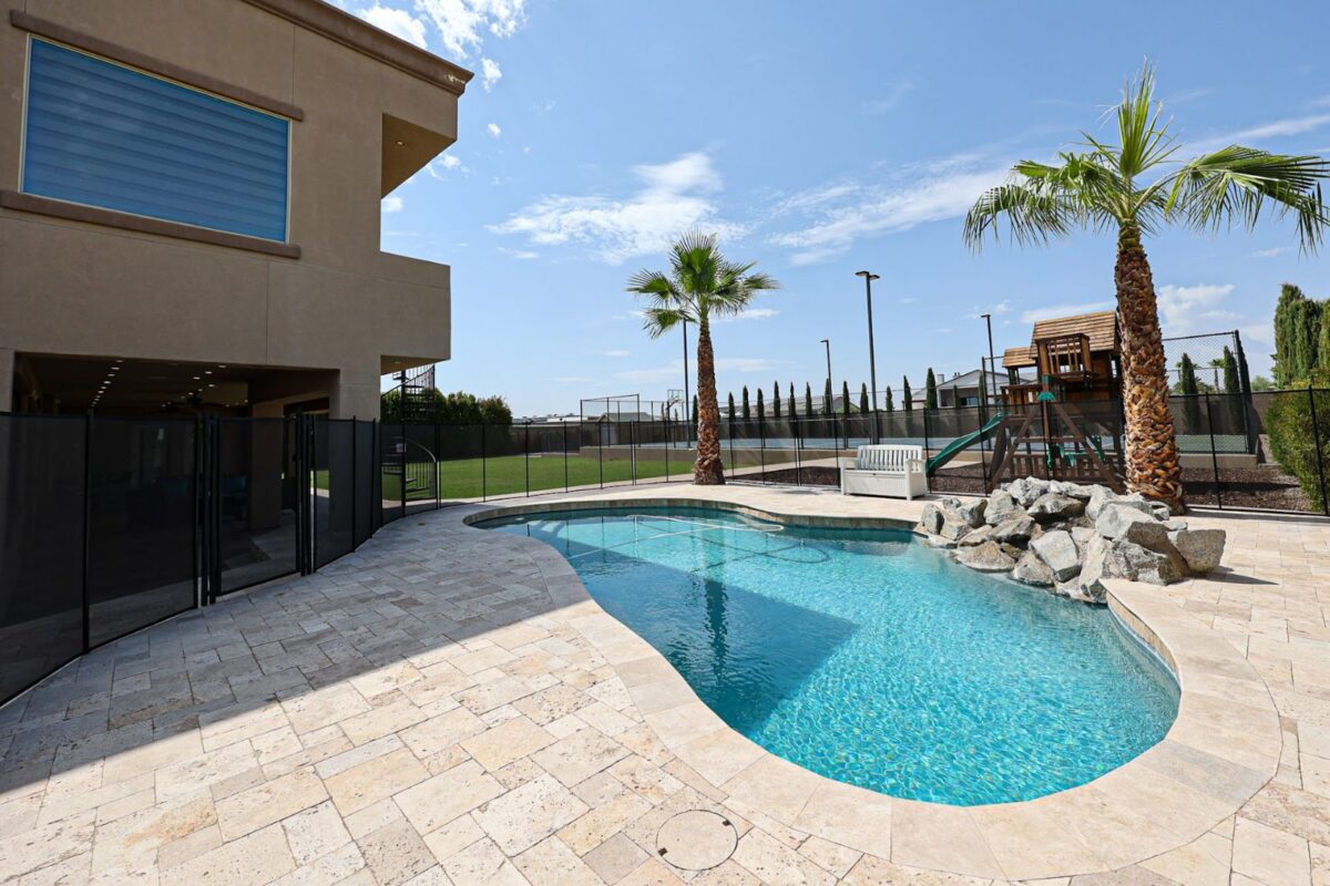 Swimming pool and patio with palm trees at the Camelback Recovery residence in Peoria