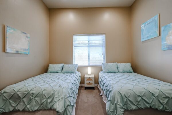 Shared bedroom with two beds at the Camelback Recovery residence in Peoria