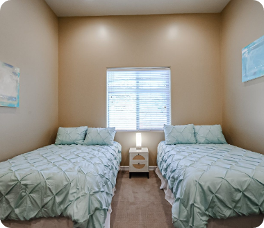 Shared bedroom with two beds at the Camelback Recovery residence in Peoria
