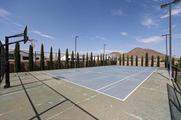 Outdoor sports court with basketball hoops at the Camelback Recovery residence in Peoria
